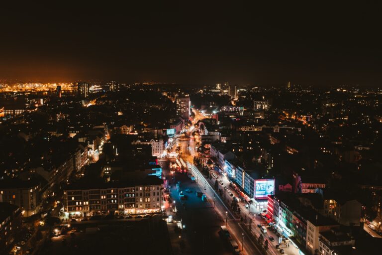 Aerial view of Hamburg's illuminated cityscape at night, showcasing vibrant streets and buildings.